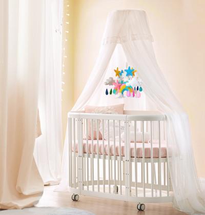 crib bed looks beautiful when paired with an amazing mosquito net and colorful cot mobile